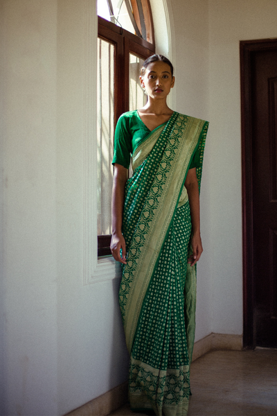 Via East emerald green handloom pure silk banarasi georgette saree with all over gold motifs and a rich detailed border